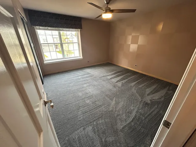 an empty room with windows and entrance