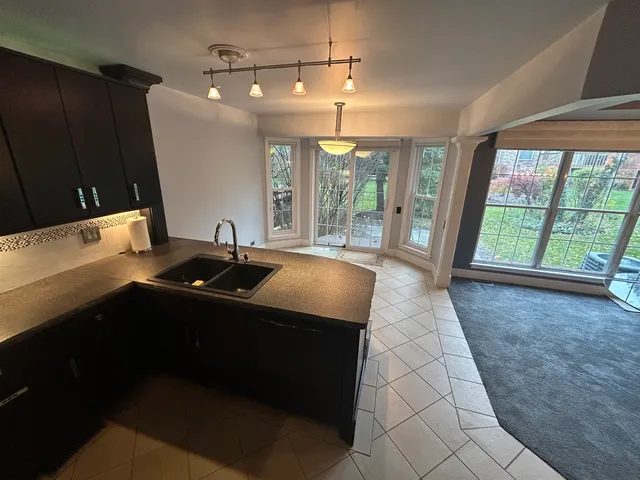 a kitchen with granite countertop a sink and a stove