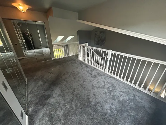 a room with stainless steel appliances granite countertop a stove a microwave and a refrigerator