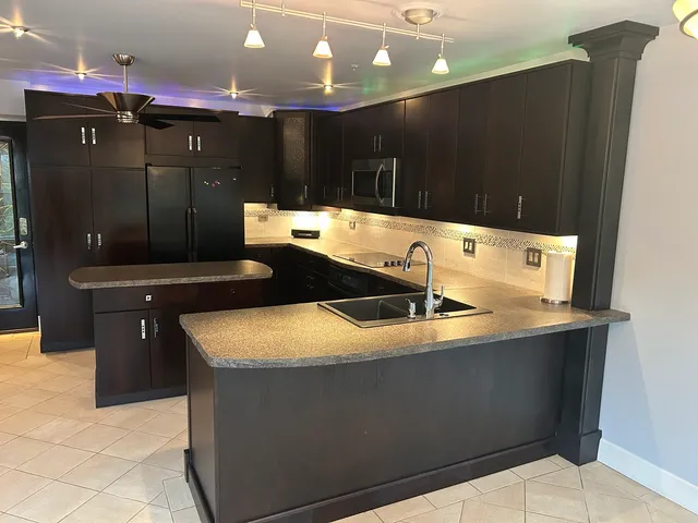 a bathroom with a sink a large mirror and a shower