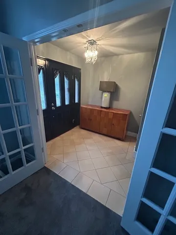 a view of staircase with white walls and a window