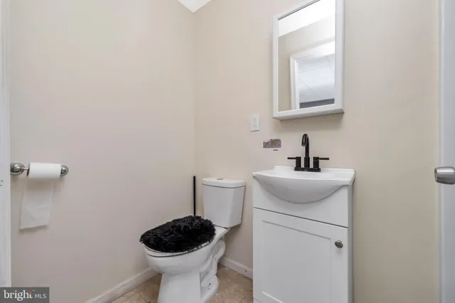 a bathroom with a toilet a sink and mirror
