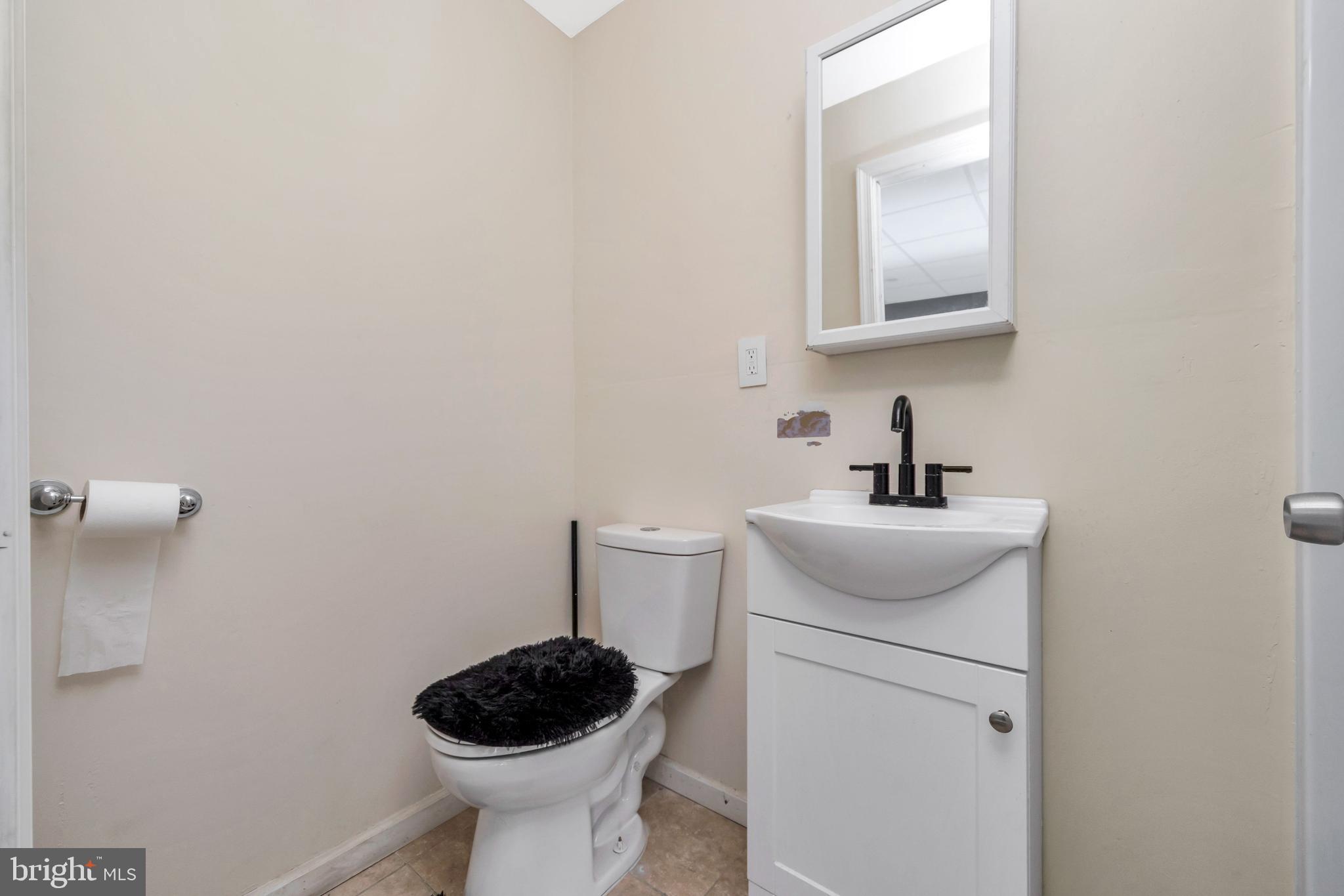 3706 Garrett Road Drexel Hill, PA 19026 - Photo 15 of 15 a bathroom with a toilet a sink and mirror