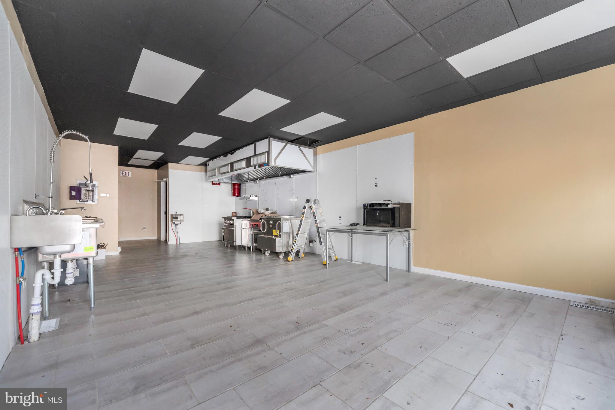 3706 Garrett Road Drexel Hill, PA 19026 - Photo 4 of 15 a view of a big room with wooden floor stainless steel appliances and chandelier