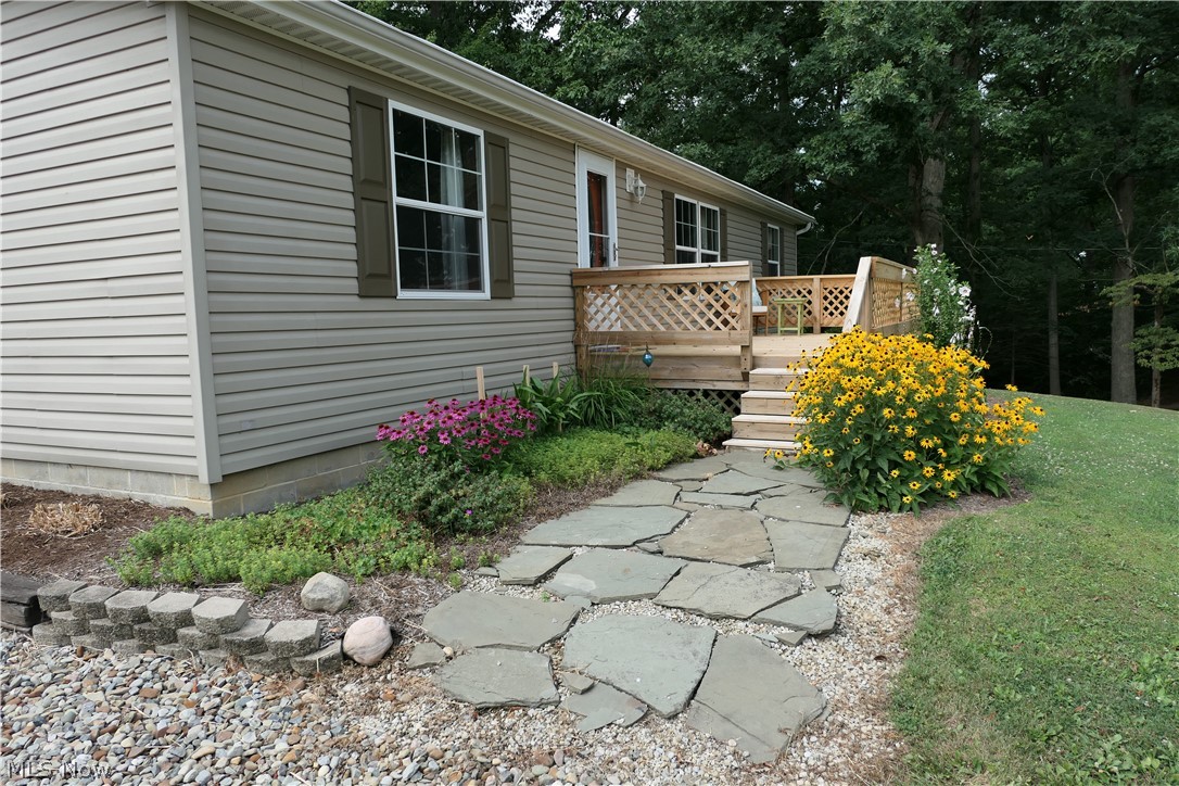 8972 Ickes Road Wooster, OH 44691 - Photo 2 of 35 The newer deck on the front affords you a view of the front yard and .... the farmer's cornfield.