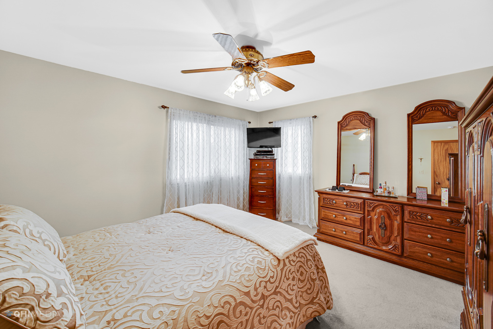 17638 Wright Street Lansing, IL 60438 - Photo 14 of 30 a bedroom with a large bed and a chandelier