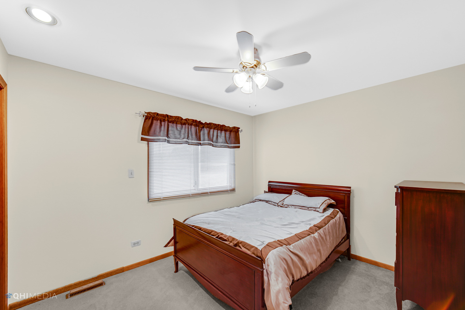 17638 Wright Street Lansing, IL 60438 - Photo 17 of 30 a bedroom with a bed and a chandelier
