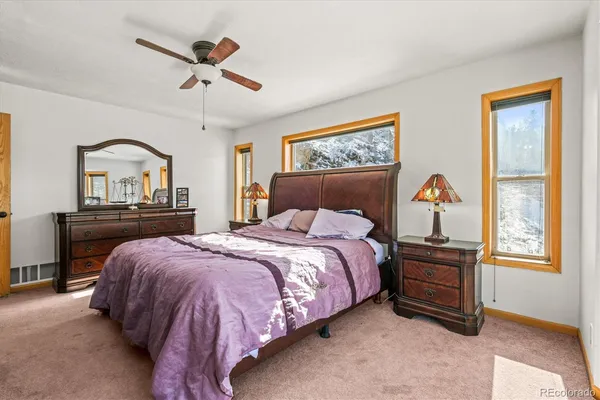 a bedroom with a bed dresser and a window