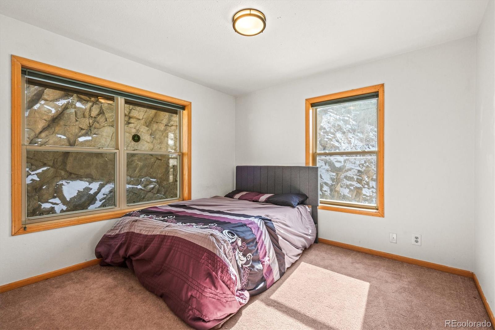 2476 South Beaver Creek Road Black Hawk, CO 80422 - Photo 15 of 21 a bed sitting in a bedroom next to a window
