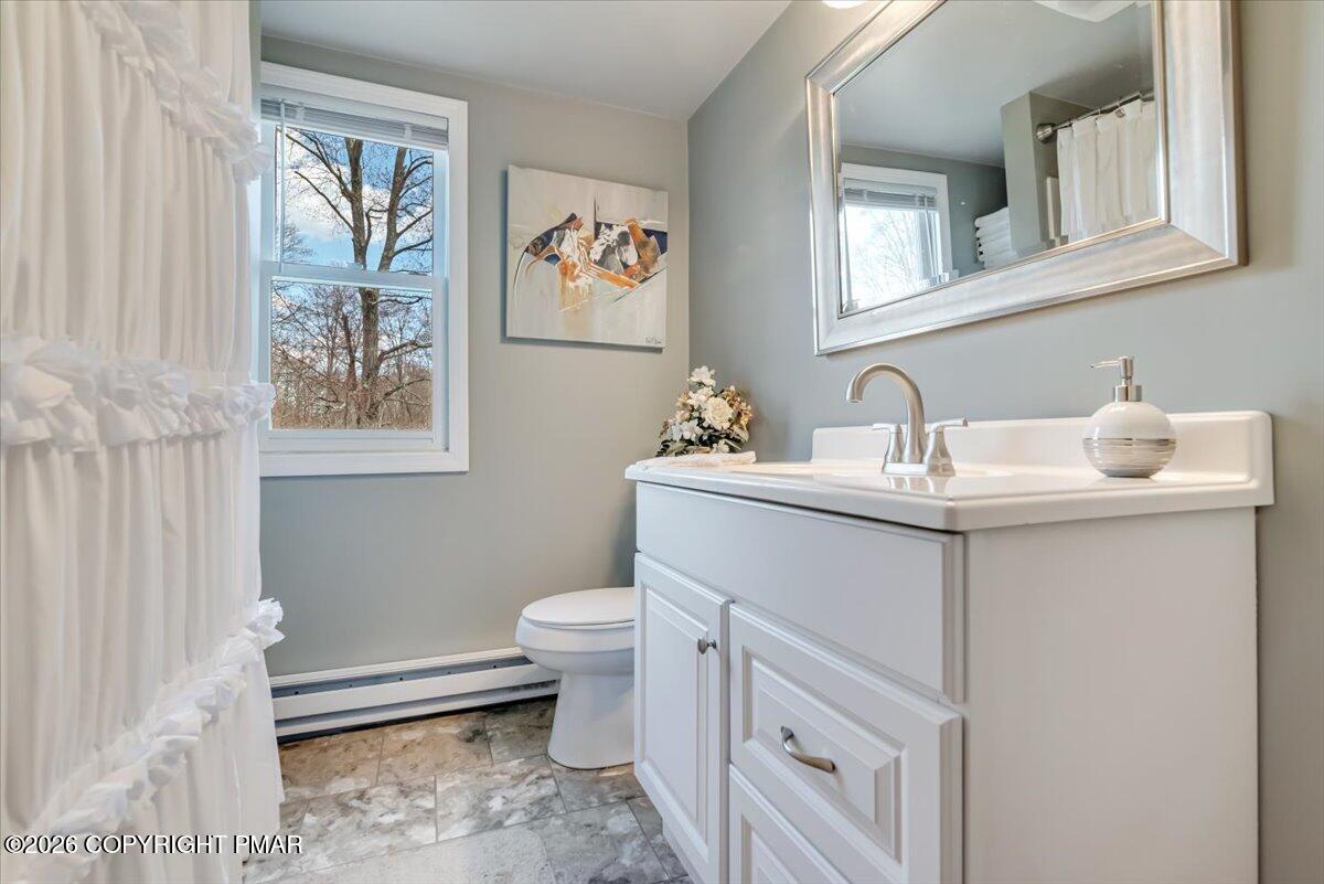253 Thomas Road Blakeslee, PA 18610 - Photo 39 of 63 a bathroom with a sink toilet and a mirror