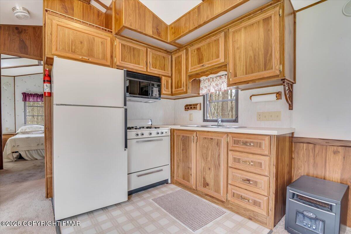 253 Thomas Road Blakeslee, PA 18610 - Photo 53 of 63 a kitchen with stainless steel appliances granite countertop a refrigerator and cabinets