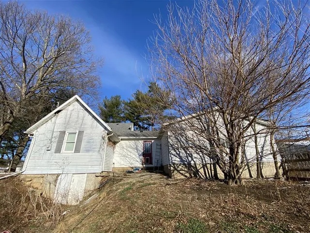 a view of a house with a yard covered with snow in the yard