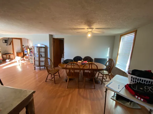 a view of a dining room with furniture wooden floor and chandelier