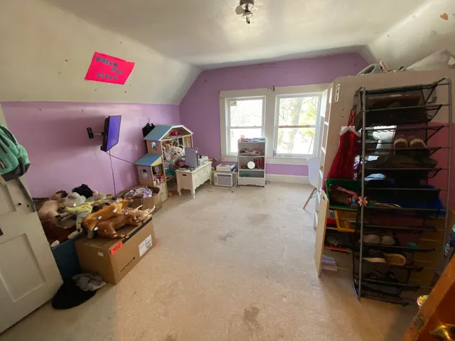 a living room with furniture a window and gym equipment