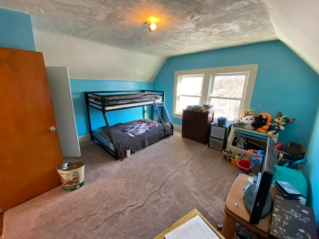 a bedroom with furniture and a window