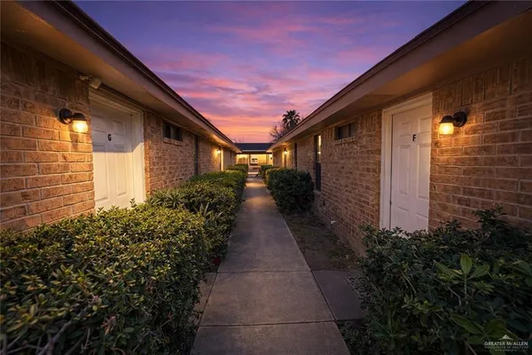 a pathway of a house with flower plants