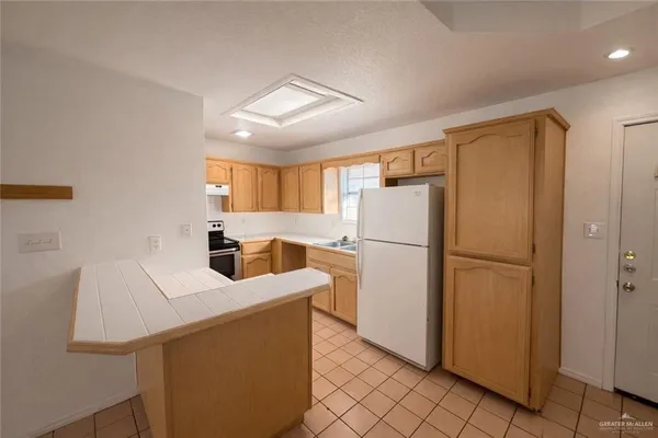 a kitchen with refrigerator and cabinets