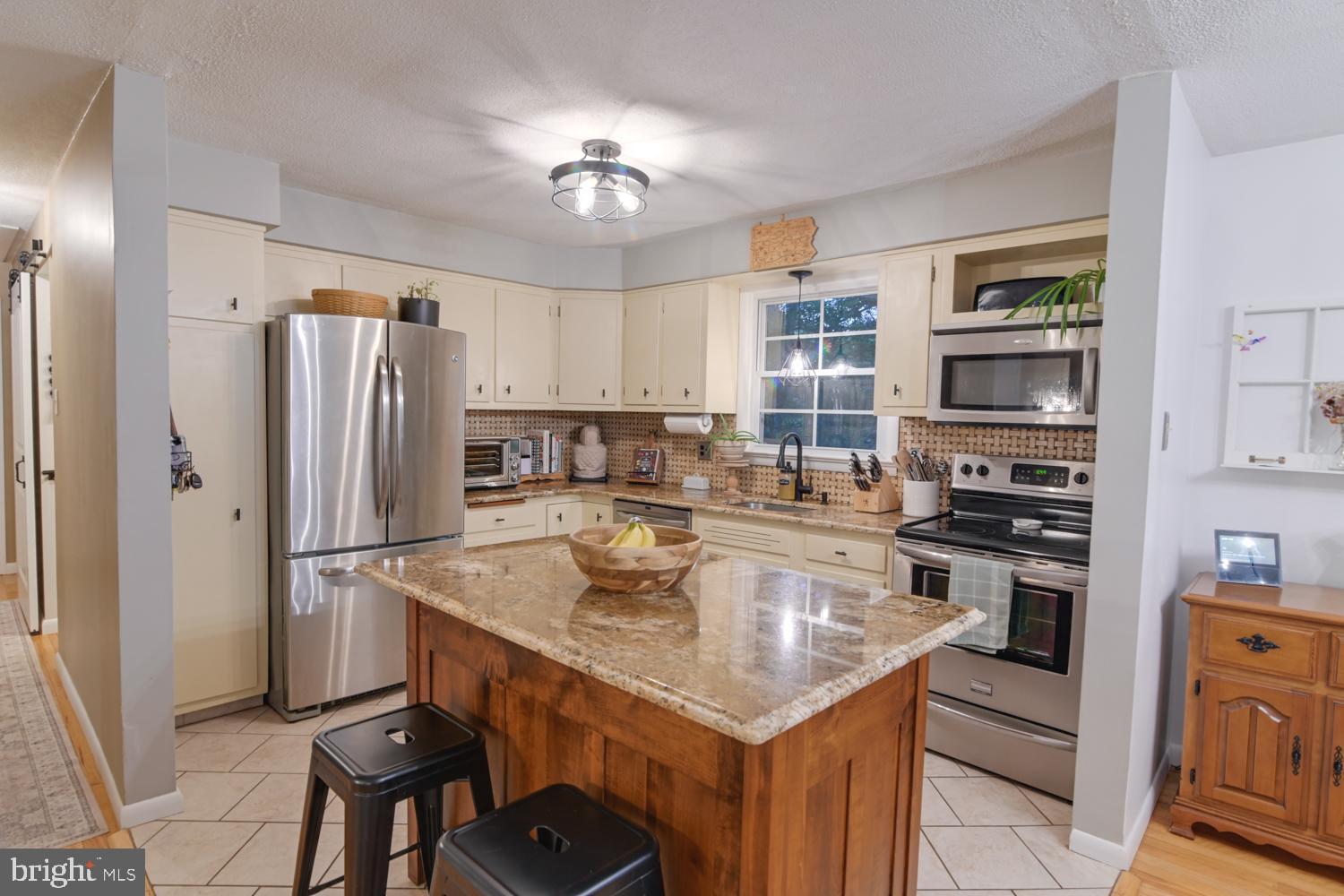146 Lexington Road York, PA 17402 - Photo 11 of 35 a kitchen with stainless steel appliances granite countertop a sink stove and refrigerator