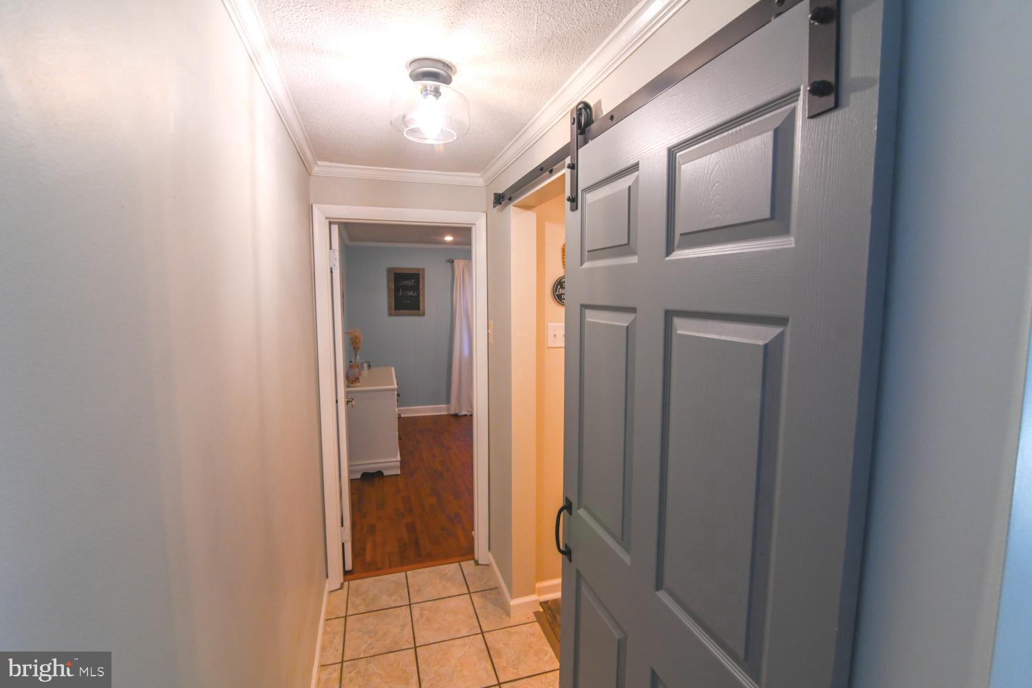 146 Lexington Road York, PA 17402 - Photo 32 of 35 a view of a hallway with wooden floor and a bathroom