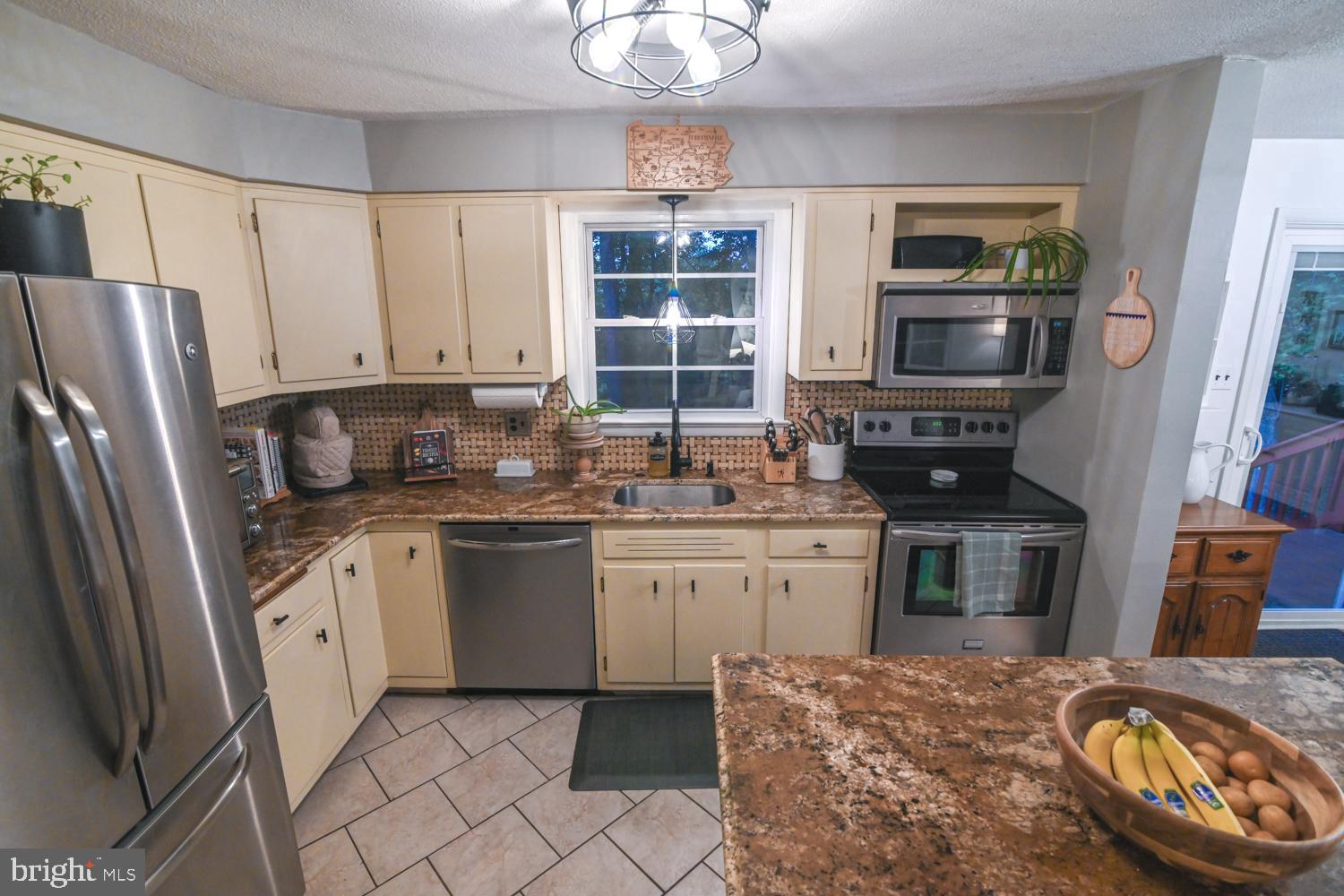 146 Lexington Road York, PA 17402 - Photo 9 of 35 a kitchen with stainless steel appliances granite countertop a stove refrigerator sink and microwave