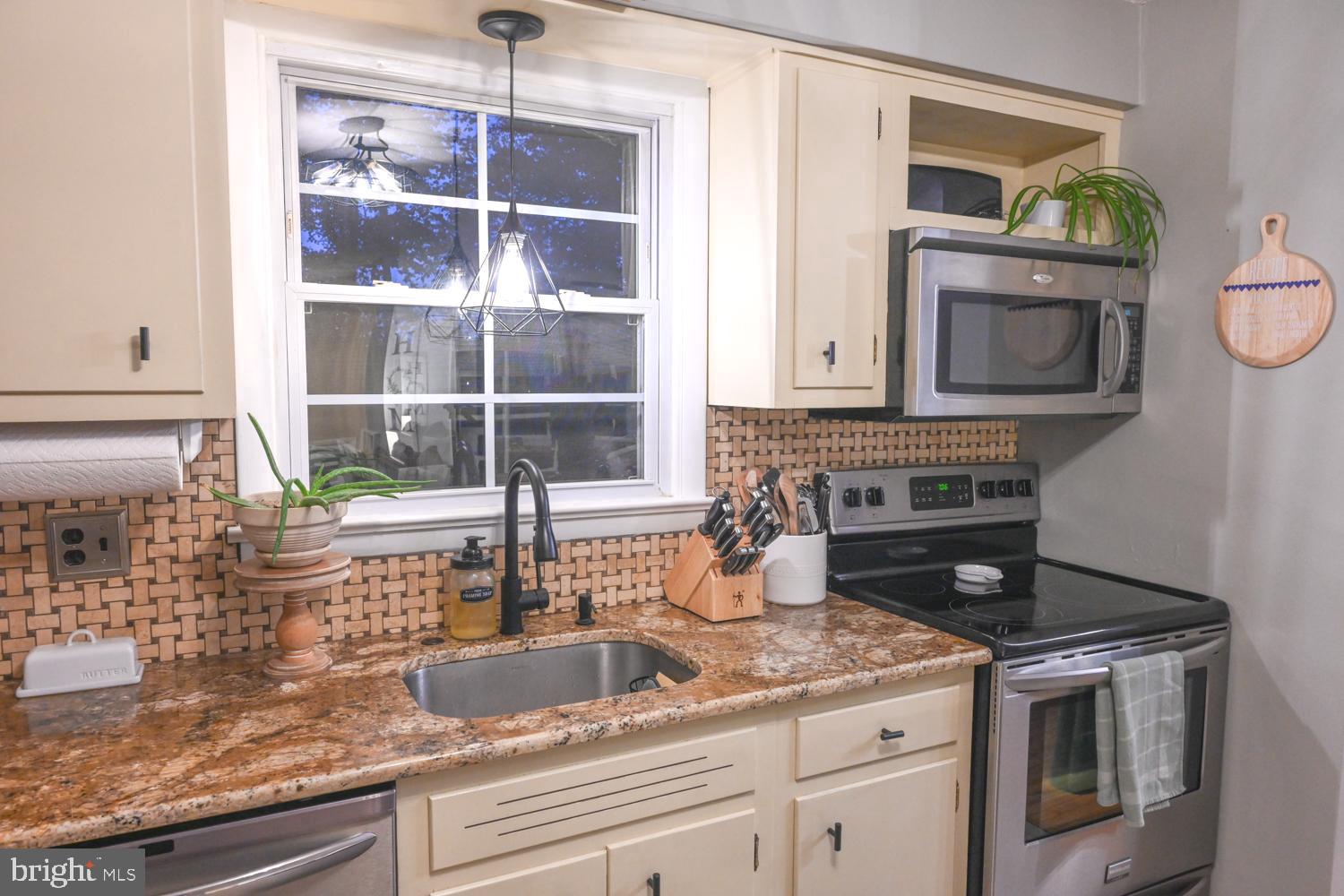 146 Lexington Road York, PA 17402 - Photo 10 of 35 a kitchen with granite countertop a stove a sink and a microwave