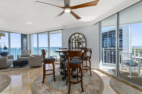 a living room with furniture a window and a dining table with rug
