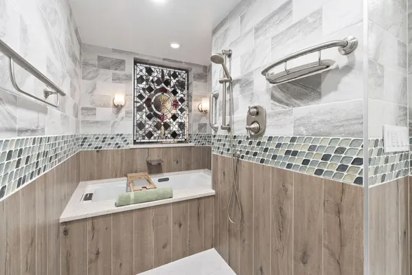 a bathroom with a bathtub and shower