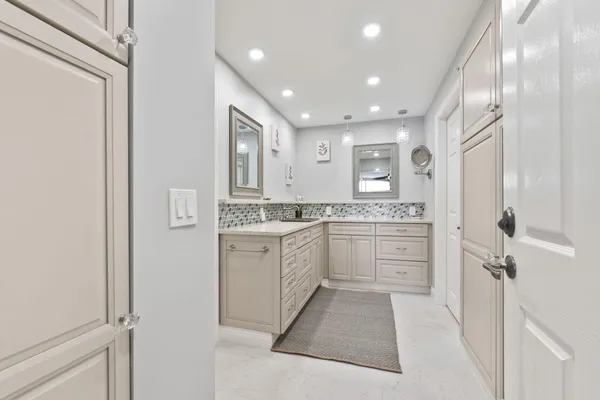 a bathroom with a double vanity sink a mirror and shower