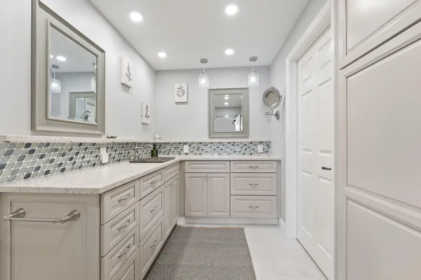 a bathroom with a toilet sink and vanity