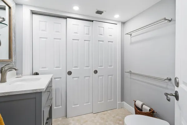 a bathroom with a sink toilet and shower