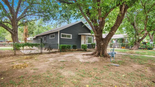a view of a house with yard and a tree
