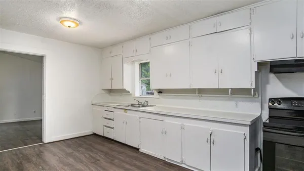 a kitchen with a sink and cabinets