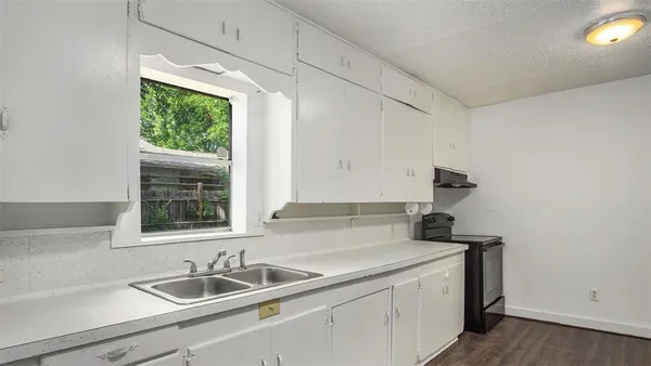 a kitchen with a sink and a window