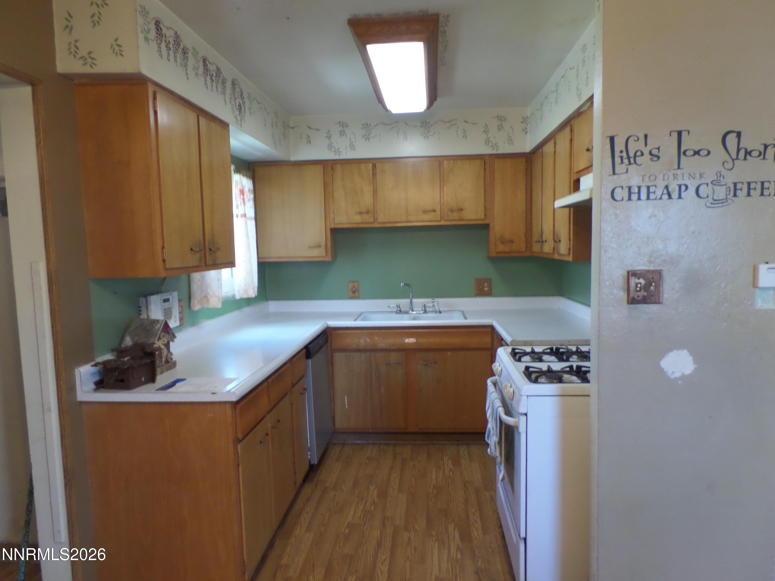 710 L Street Sparks, NV 89431 - Photo 3 of 11 a kitchen with a sink a stove and cabinets