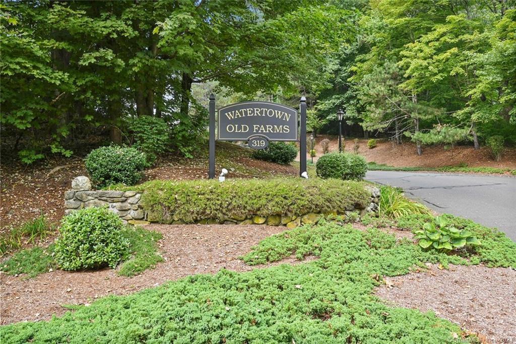 319 Thomaston Road, Unit 27 Watertown, CT 06795 - Photo 1 of 1 a sign that is sitting in front of a tree