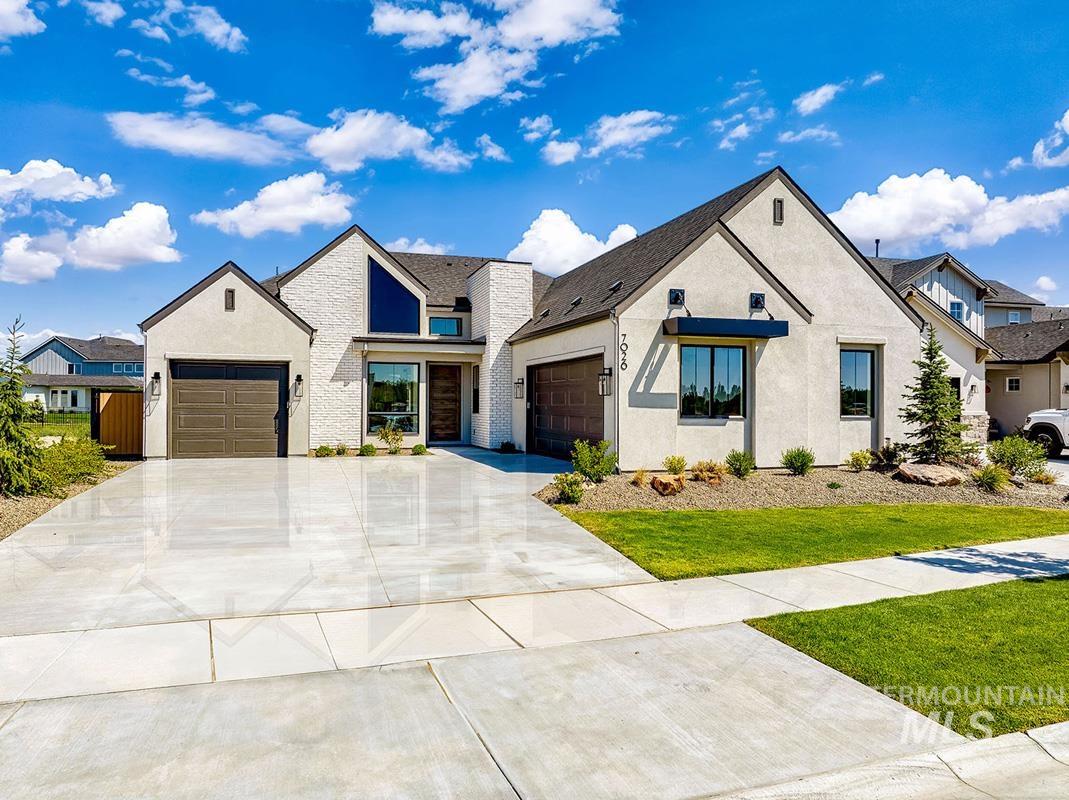 7026 Saddle Bred Way Star, ID 83669 - Photo 1 of 49 Modern inspired farmhouse with a garage, concrete driveway, stucco siding, and a front yard
