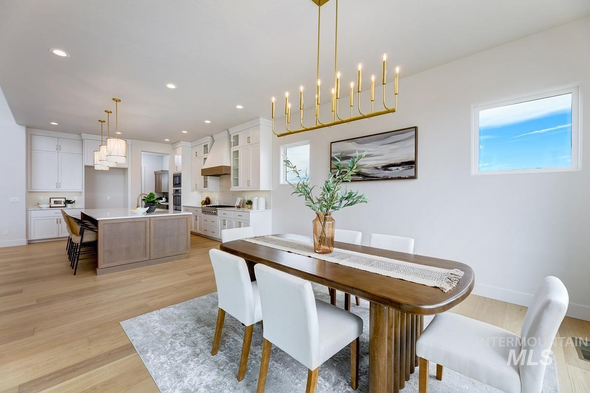 7026 Saddle Bred Way Star, ID 83669 - Photo 11 of 49 Dining space with light wood-type flooring and hanging lights