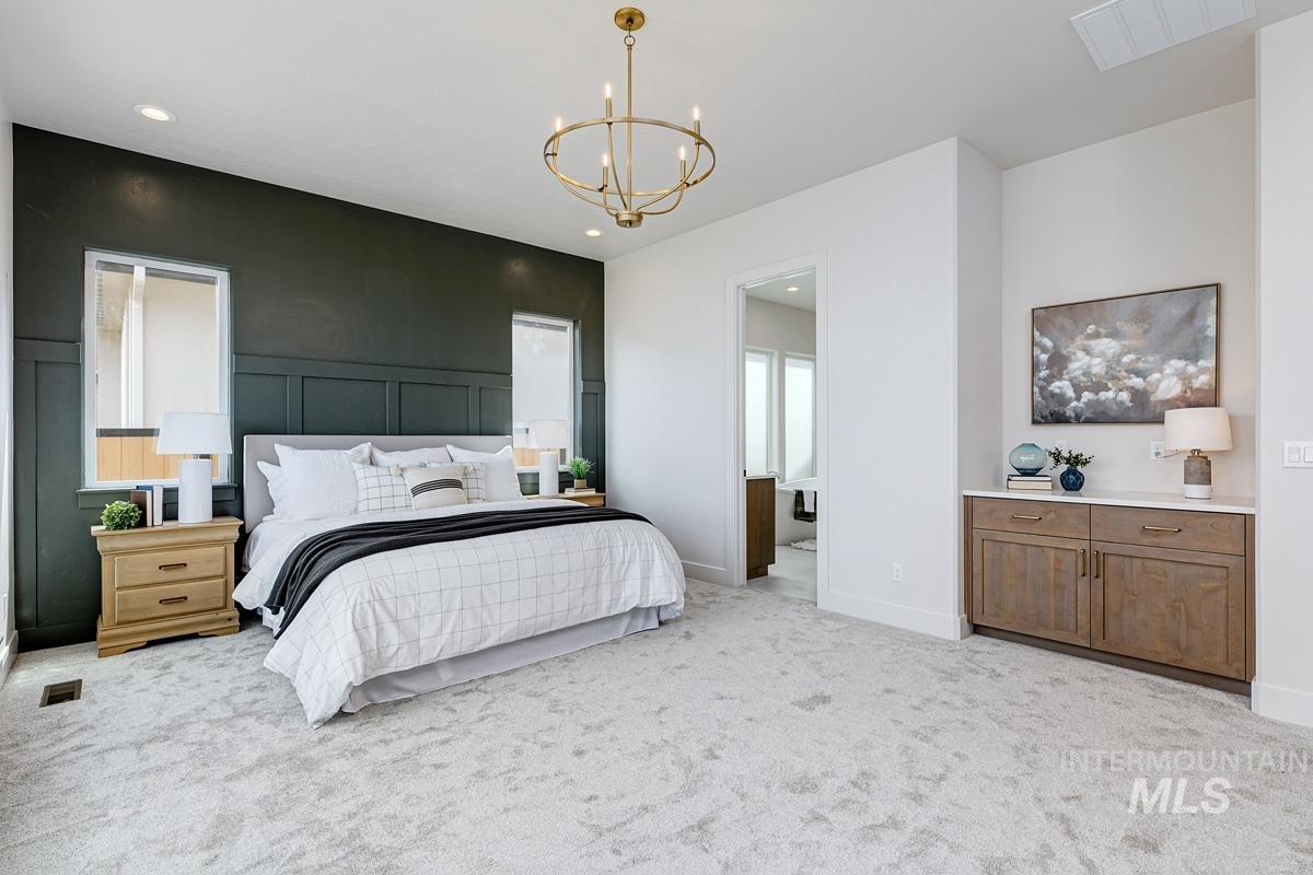 7026 Saddle Bred Way Star, ID 83669 - Photo 17 of 49 Bedroom with light carpet, a chandelier, and a decorative wall
