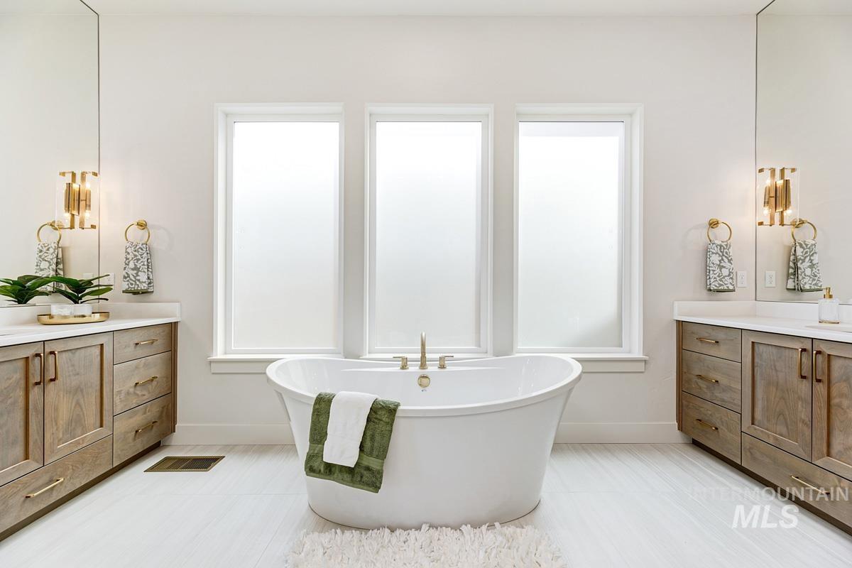 7026 Saddle Bred Way Star, ID 83669 - Photo 18 of 49 Full bathroom with vanity, plenty of natural light, a freestanding bath, and light tile patterned floors