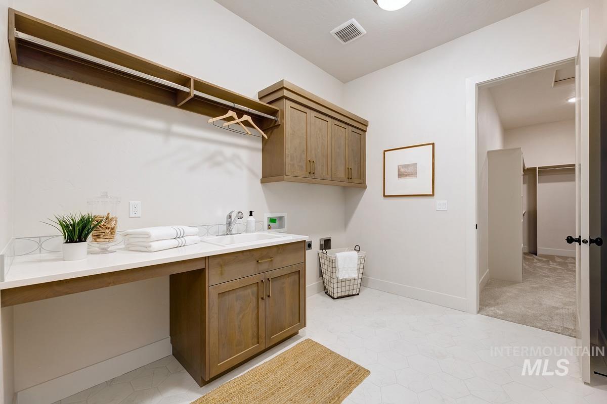 7026 Saddle Bred Way Star, ID 83669 - Photo 22 of 49 Laundry area with hookup for a washing machine and cabinet space