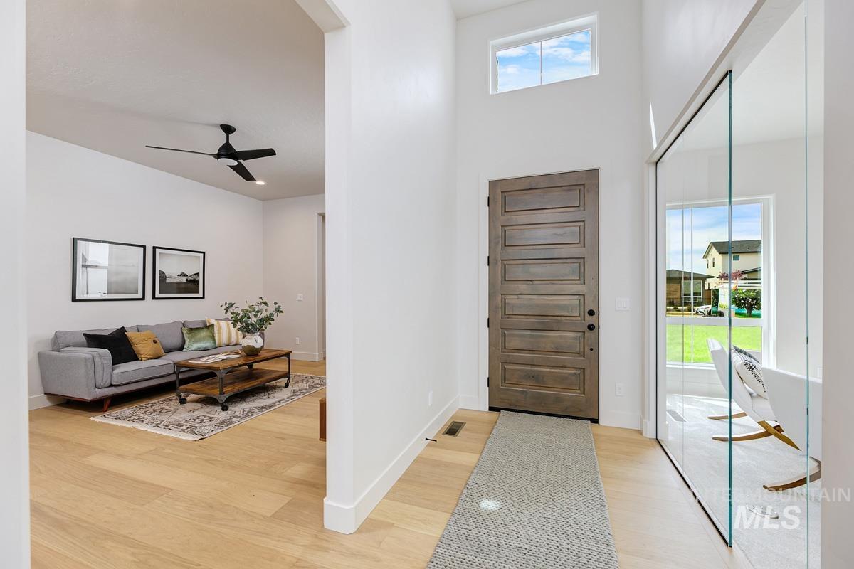 7026 Saddle Bred Way Star, ID 83669 - Photo 23 of 49 Foyer entrance with light wood-style floors, a high ceiling, and ceiling fan