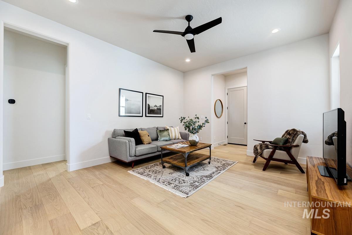 7026 Saddle Bred Way Star, ID 83669 - Photo 26 of 49 Living room with a ceiling fan, light wood-type flooring, and recessed lighting