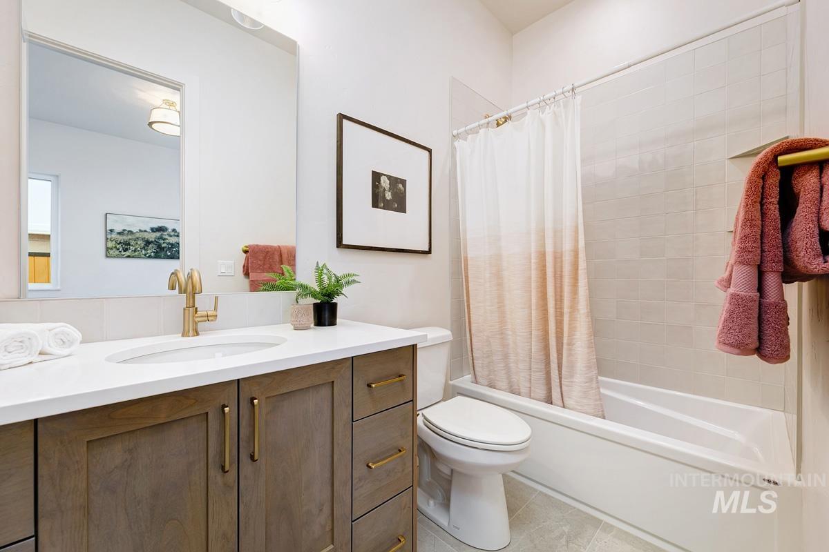 7026 Saddle Bred Way Star, ID 83669 - Photo 28 of 49 Bathroom with shower / bath combination with curtain, vanity, and light tile patterned floors