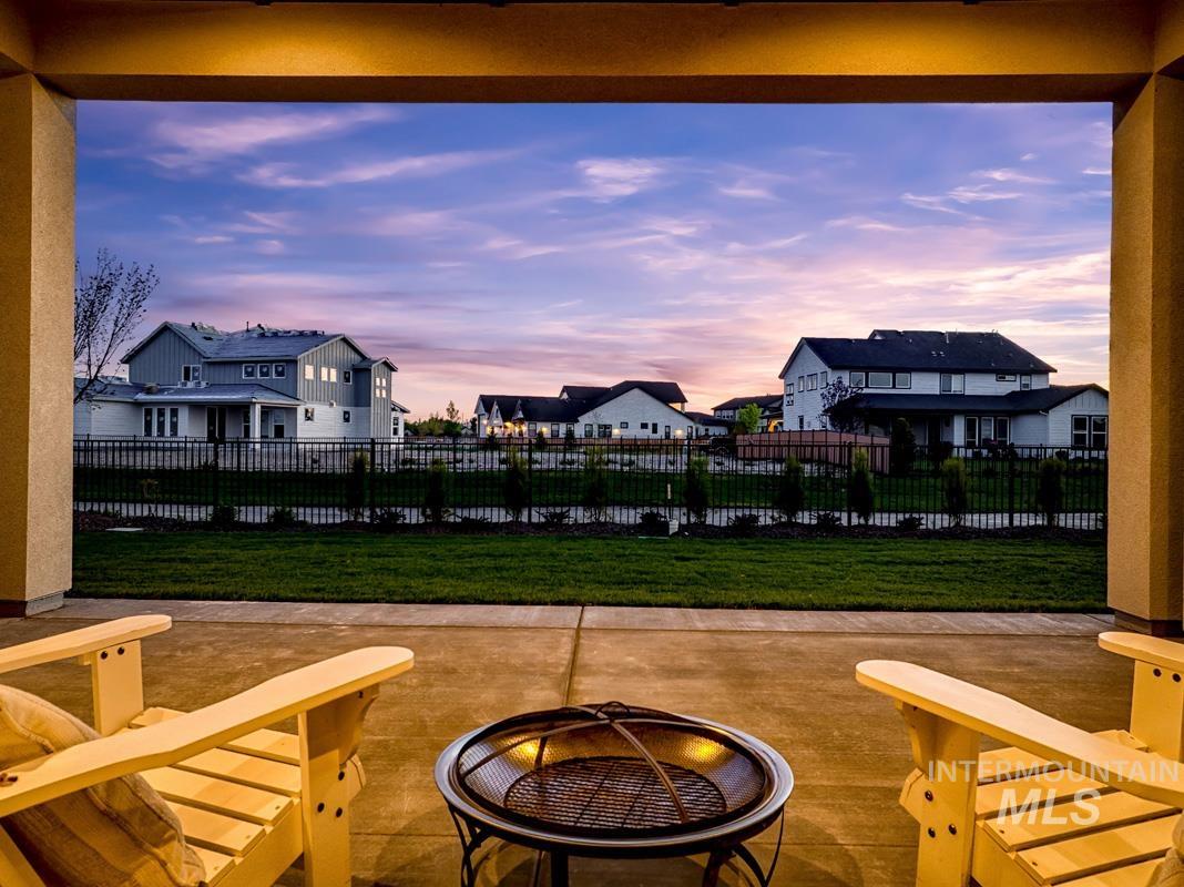 7026 Saddle Bred Way Star, ID 83669 - Photo 32 of 49 Fenced backyard featuring a patio, a residential view, and a fire pit