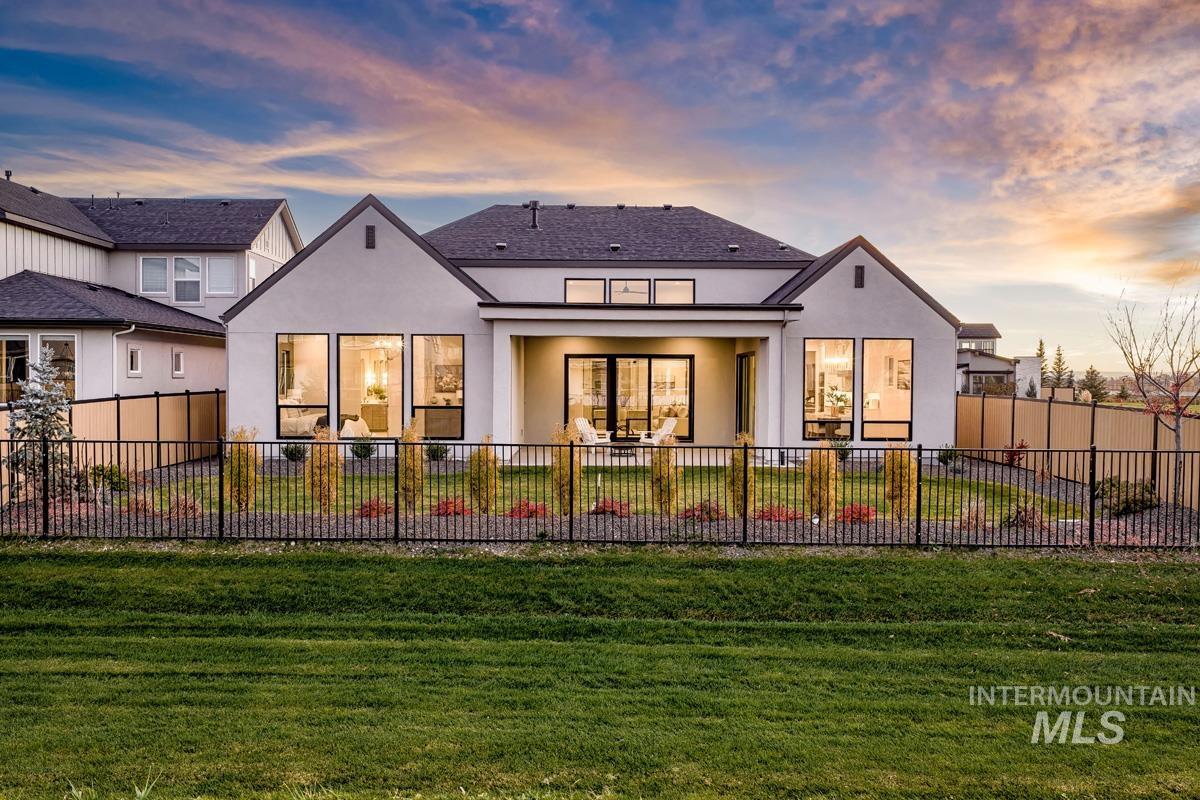 7026 Saddle Bred Way Star, ID 83669 - Photo 34 of 49 Rear view of house with a fenced backyard, stucco siding, and a patio area