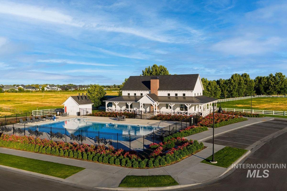 7026 Saddle Bred Way Star, ID 83669 - Photo 40 of 49 Community clubhouse featuring a covered porch, an expansive pool, and a white picket fence perimeter