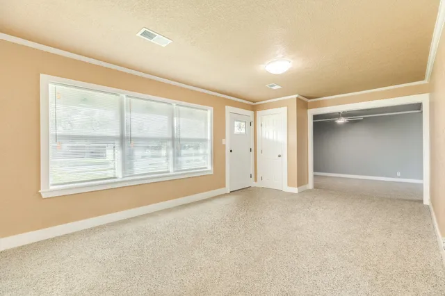 an empty room with a empty space and windows