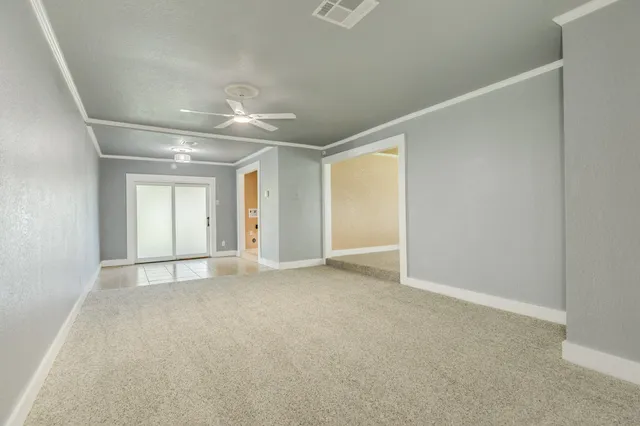 an empty room with closet and windows