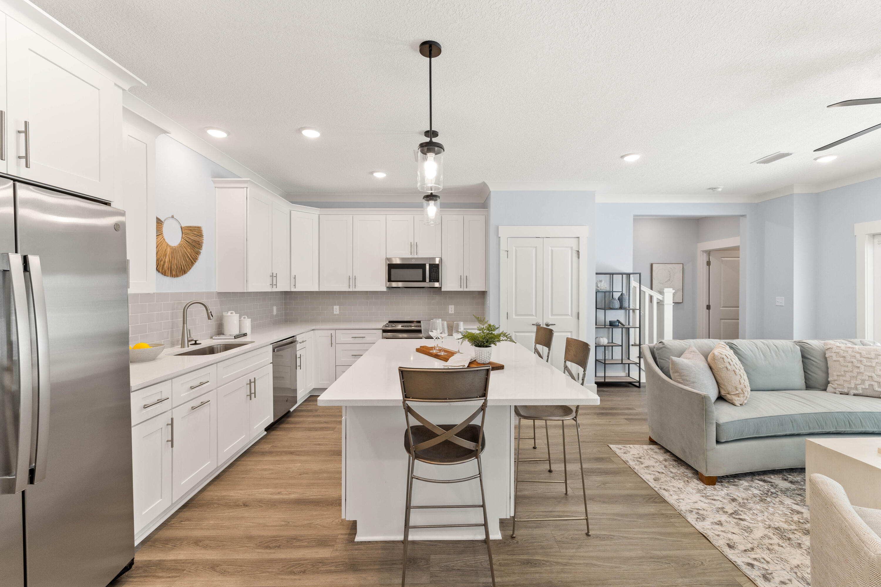 100 Beach Drive, Unit 9 Destin, FL 32541 - Photo 10 of 33 a kitchen with a refrigerator and white cabinets