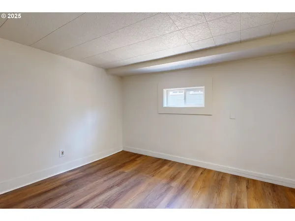 a view of an empty room and wooden floor